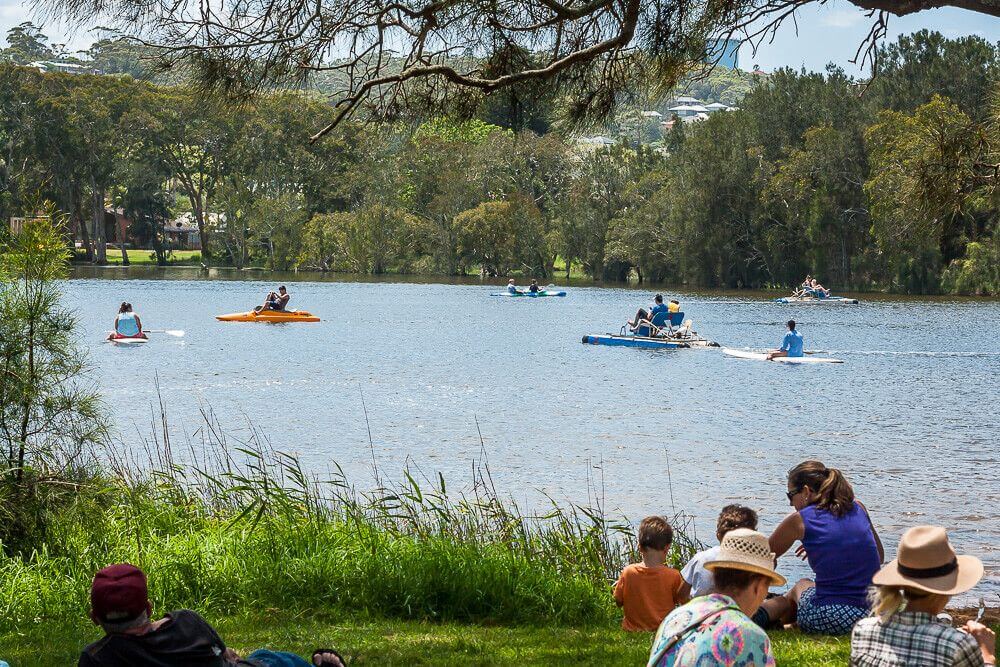 Families and kids enjoying paddle boats and water activities at Aquafun