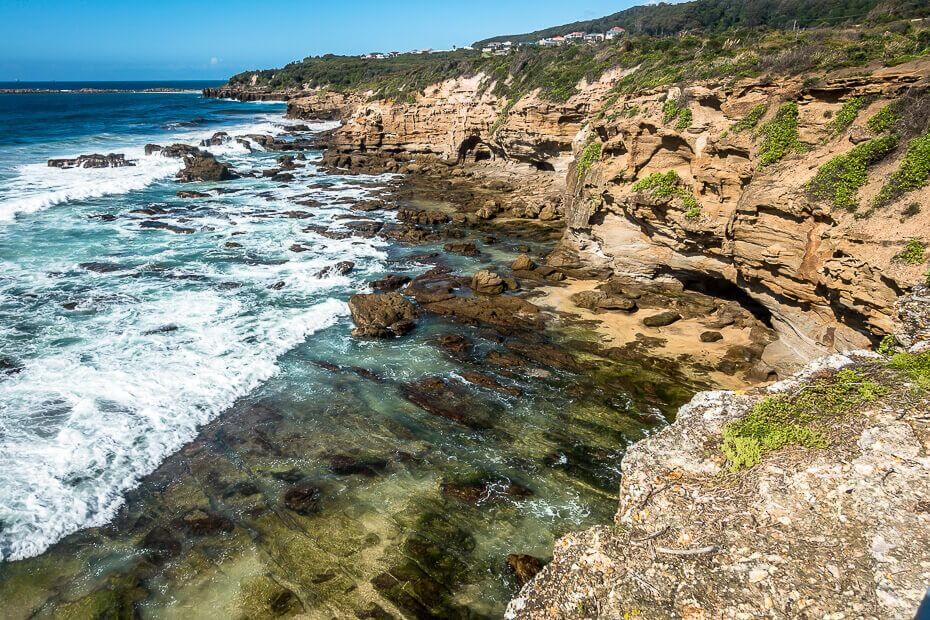 Rocky coastline and sea caves viewed from the Caves Beach lookout