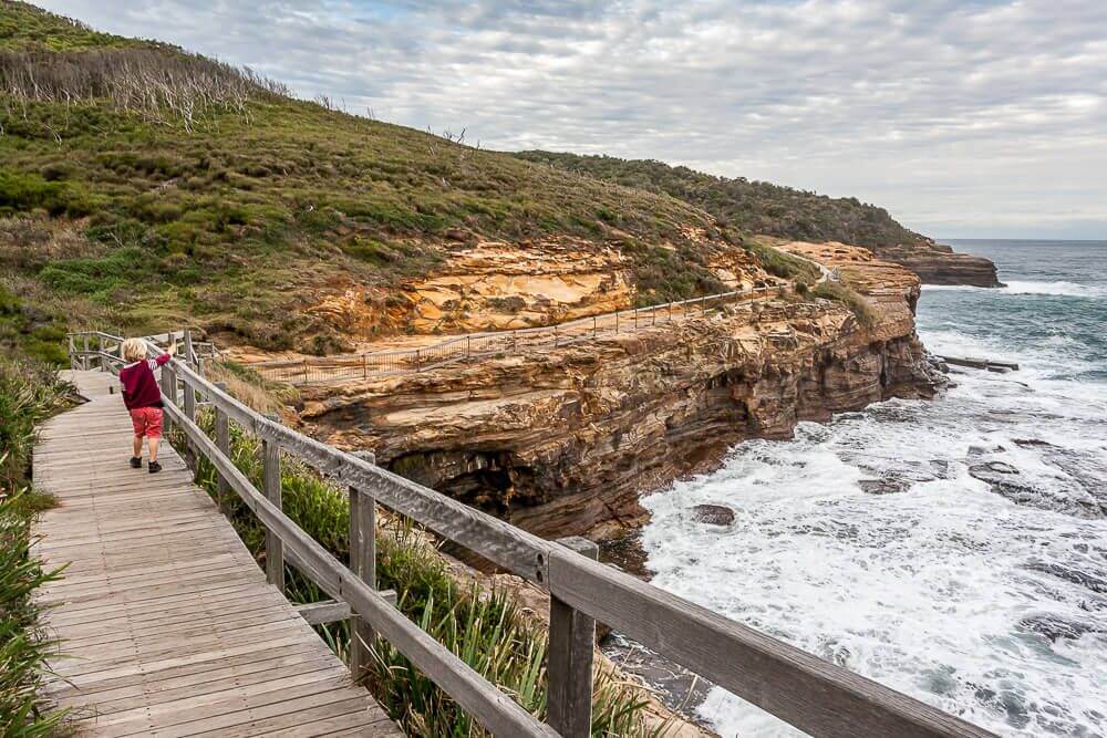 Family walking along a coastal bushwalk on the Central Coast NSW