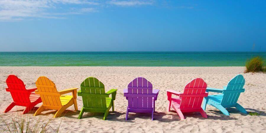 Colourful beach chairs lined up on sandy beach in Australia