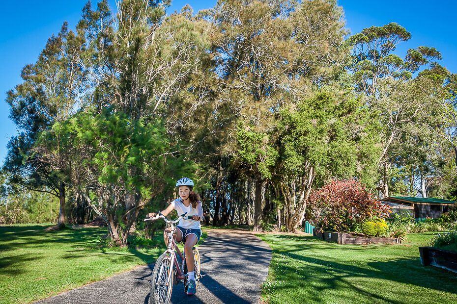Child riding a bike on a family-friendly cycling path on the Central Coast