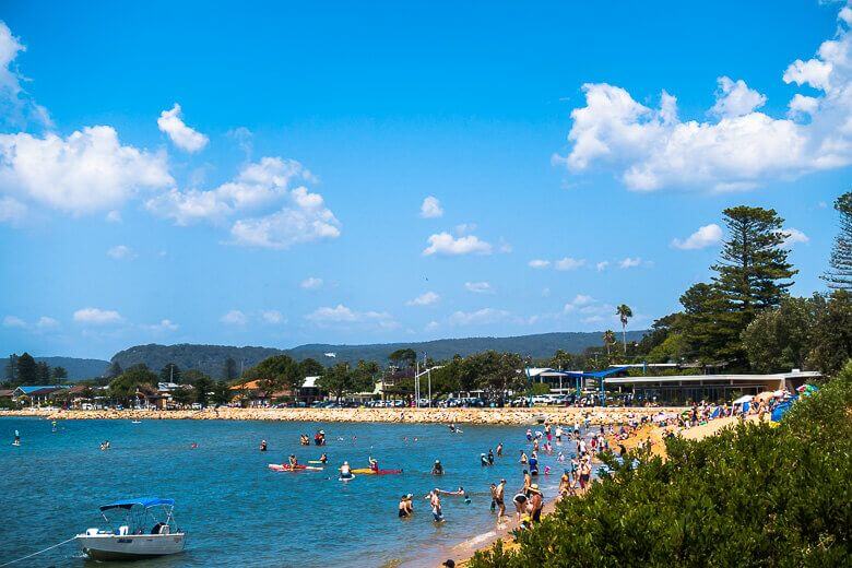 People enjoying the shoreline at Ettalong Beach