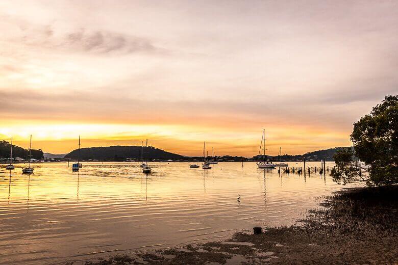 Sunset over Hardys Bay near Killcare with boats on the water, Central Coast NSW