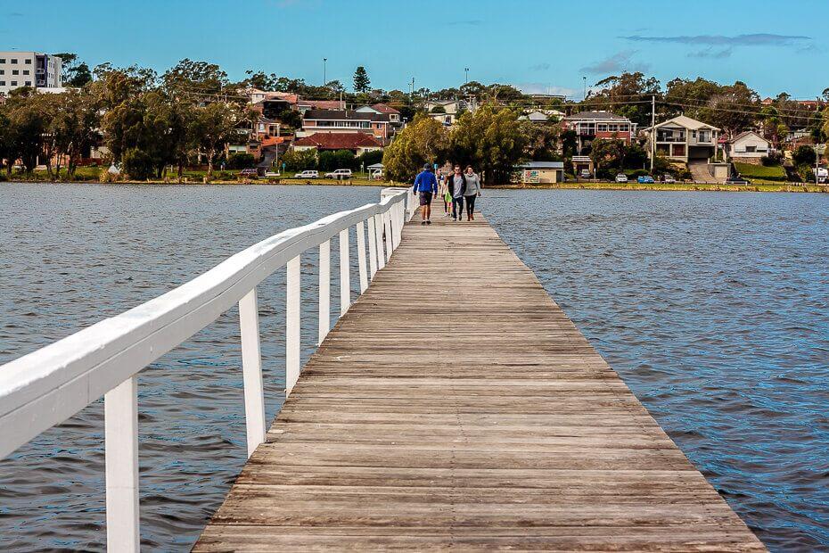 People walking along Long Jetty over Tuggerah Lake on the Central Coast NSW
