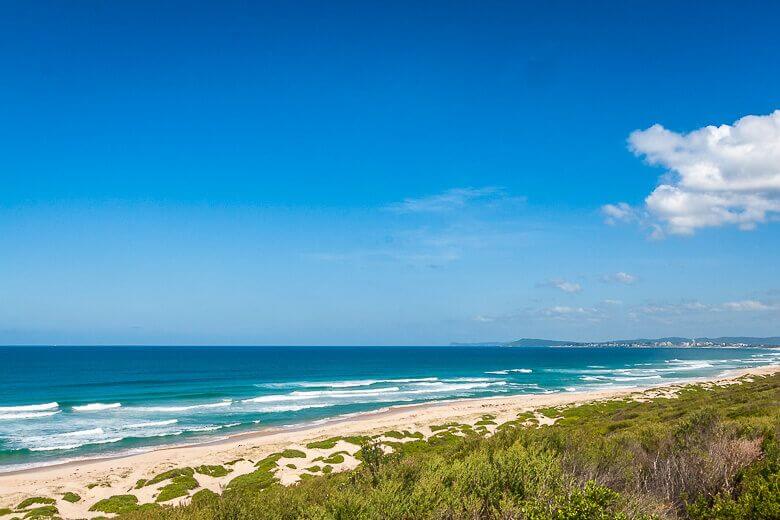 Long stretch of sandy shoreline and ocean views at Pelican Beach on the Central Coast