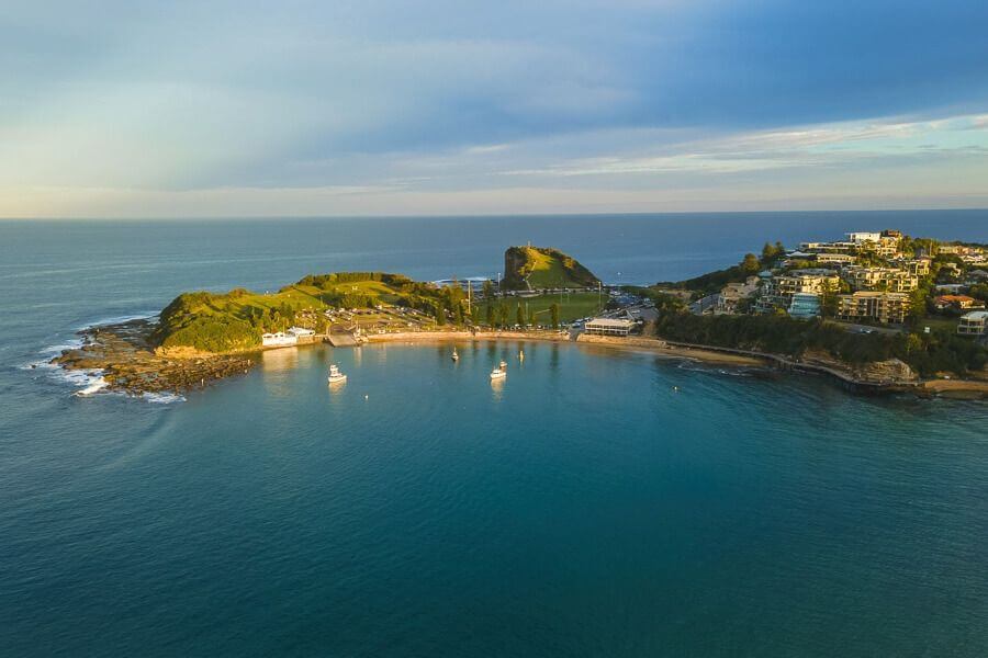 Aerial view of Terrigal Haven with calm waters, headland and boats, Central Coast NSW
