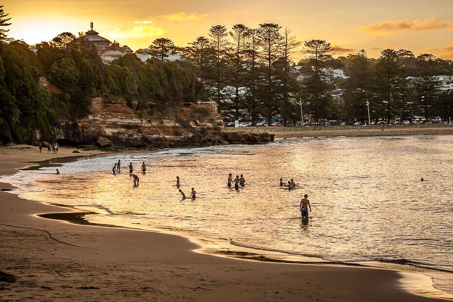 People swimming at Terrigal Haven during sunset