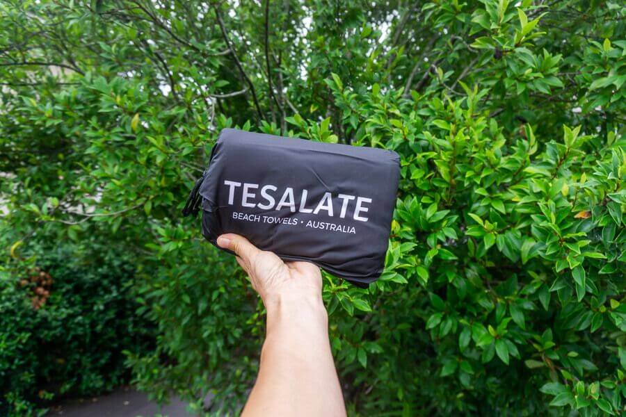 Tesalate beach towel folded inside compact travel pouch