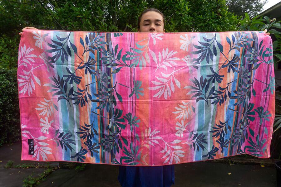 Tesalate beach towel shown full size with colourful tropical pattern