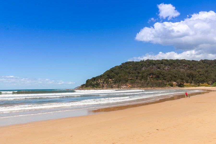 Wide sandy shoreline and headland at Umina Beach on the Central Coast