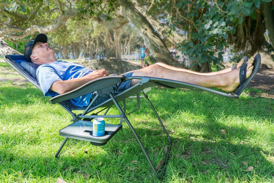 OZtrail Sun Lounge Jumbo reclining camping chair set up on grass