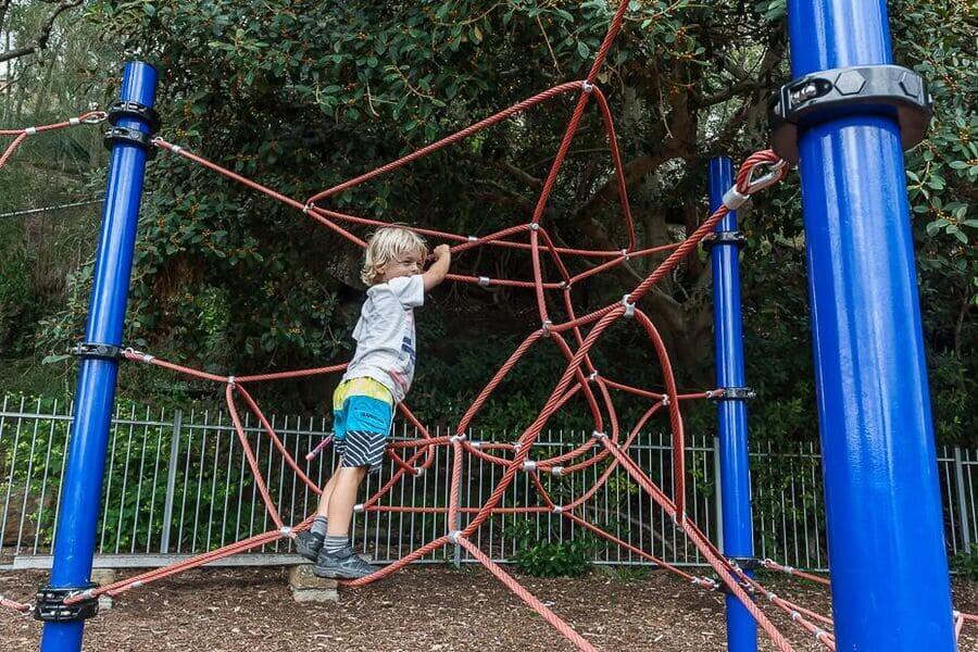 Child playing on a climbing frame at a playground in Brooklyn NSW on the Central Coast