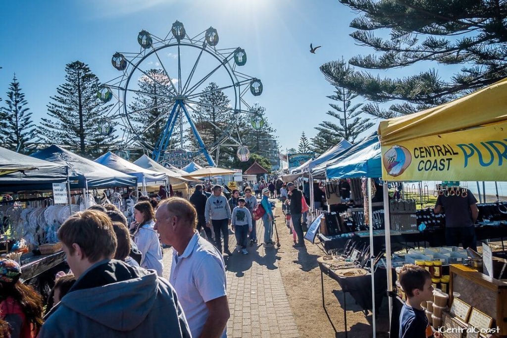 Market stalls and visitors along the waterfront at The Entrance on the Central Coast