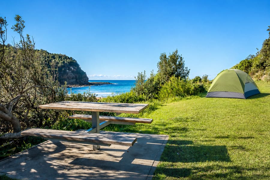 Tent and picnic area overlooking Little Beach in Bouddi National Park.