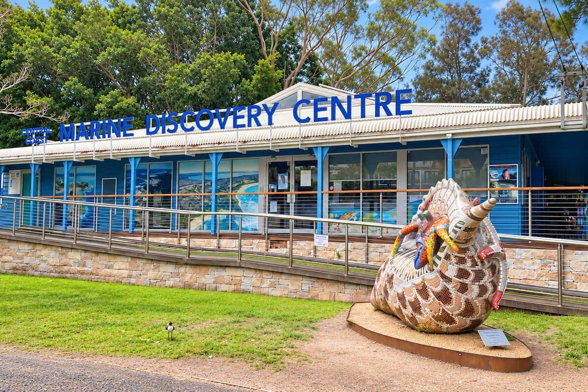 Central Coast Marine Discovery Centre exterior with accessible ramp and large decorated shell artwork