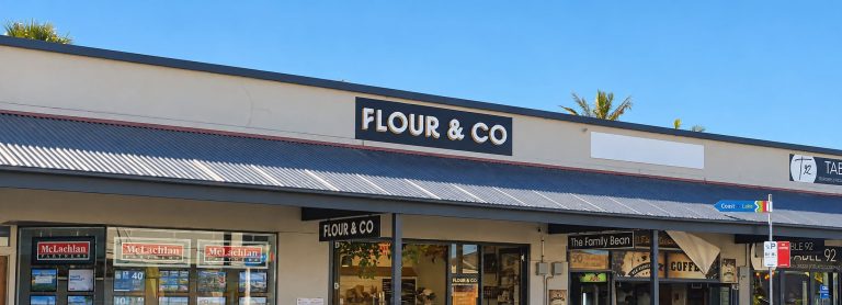 flour and co cafe shopfront sign neighbouring businesses 768x278