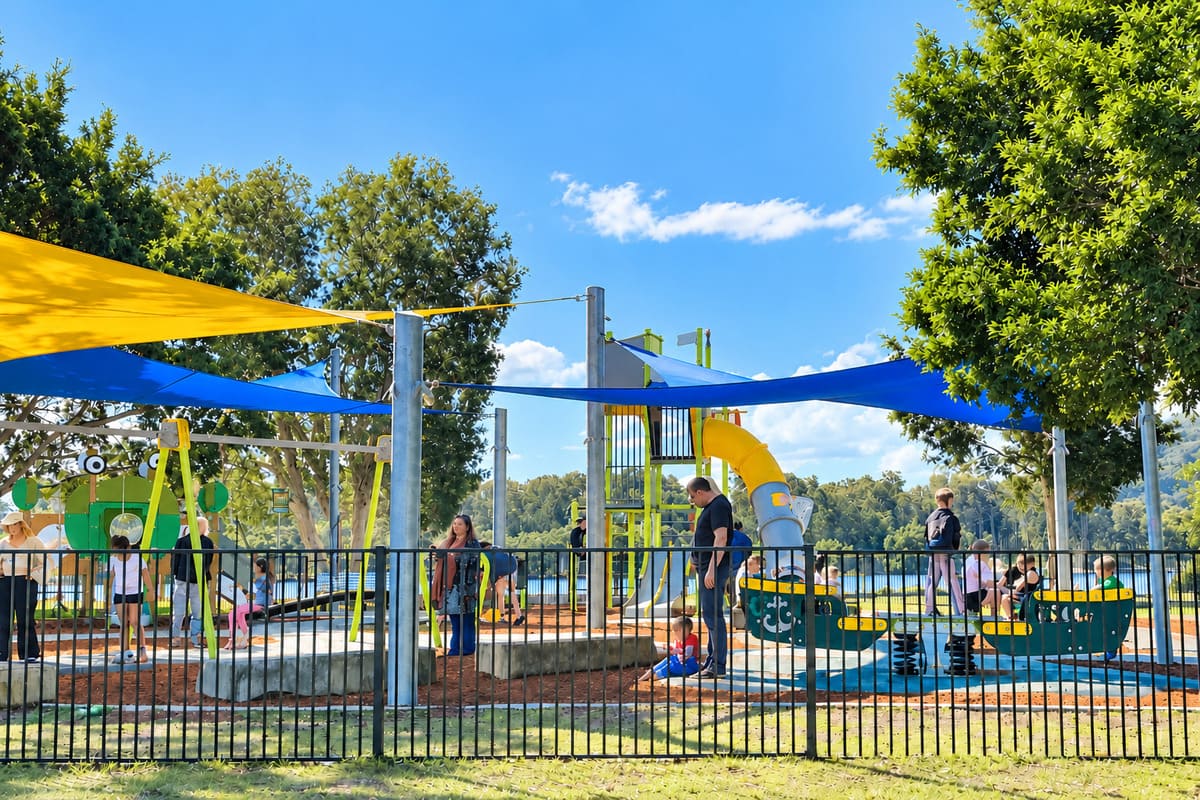 Lions Park playground in Woy Woy with fenced play area and shade sails