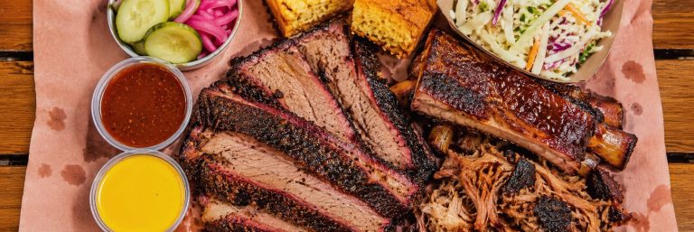 smoked brisket bbq ribs pulled pork cornbread coleslaw platter 768x257