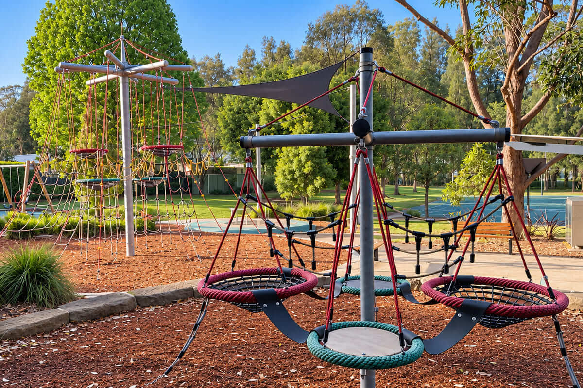 Sun Valley playground in Green Point with a tall rope climbing tower, basket swings and shade sail