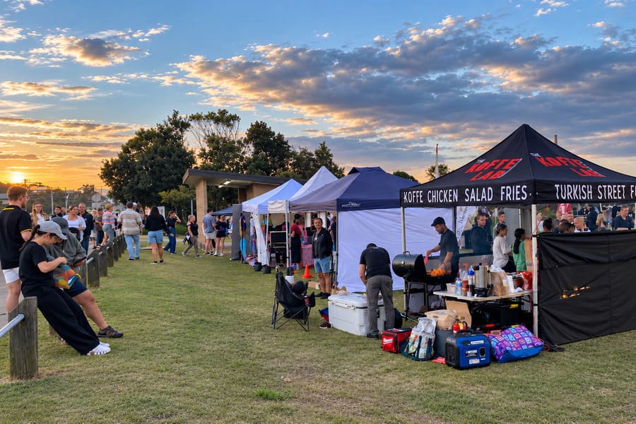 Crowd and Turkish street food stall at the Sunset Markets in Norah Head