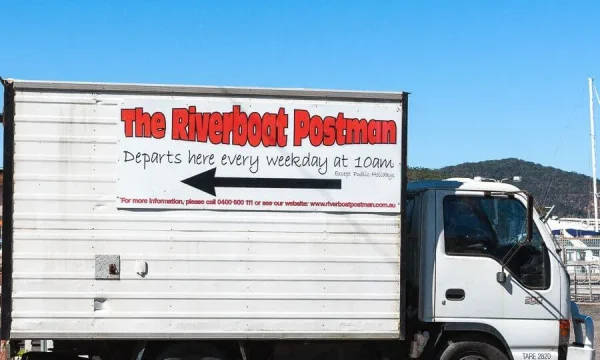 Riverboat Postman sign showing departure information on the Hawkesbury River