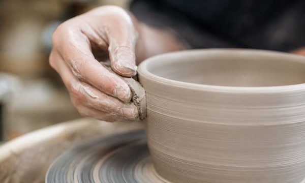 Hands shaping clay pottery during a ceramic workshop on the Central Coast NSW