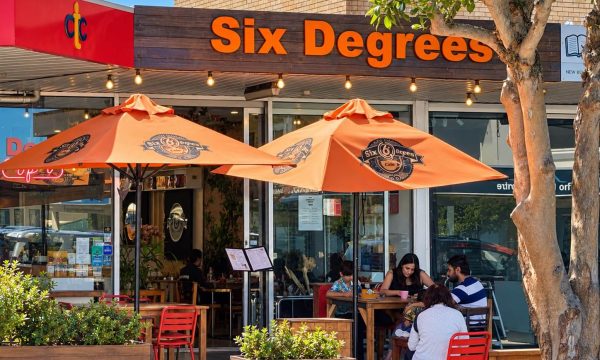 Six Degrees Cafe in Umina Beach with orange umbrellas and outdoor dining tables