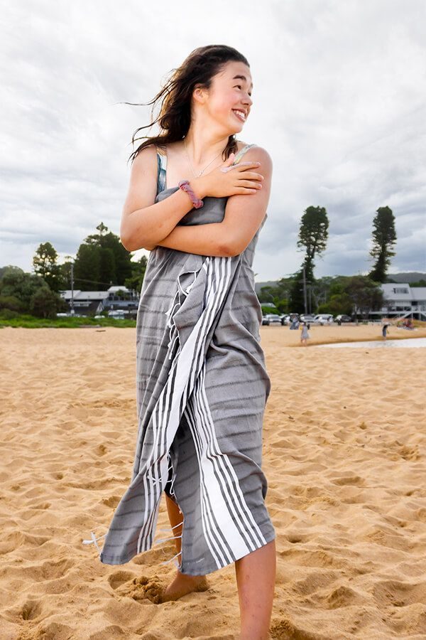 woman-wearing-beach-towel-on-sand